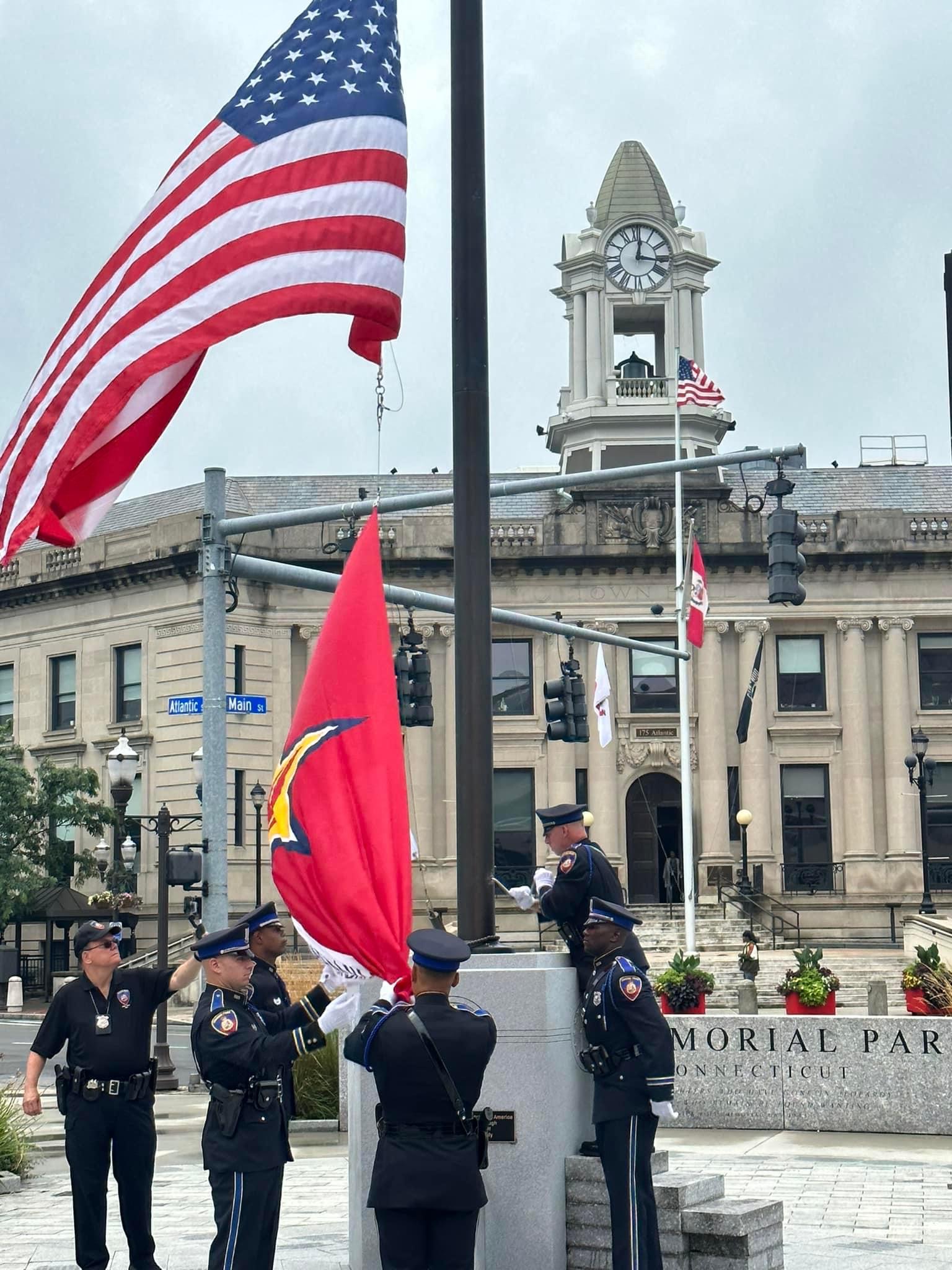 The Honor and Remember Flag is raised by members of the Stamford Police Department Honor Guard in veterans park 