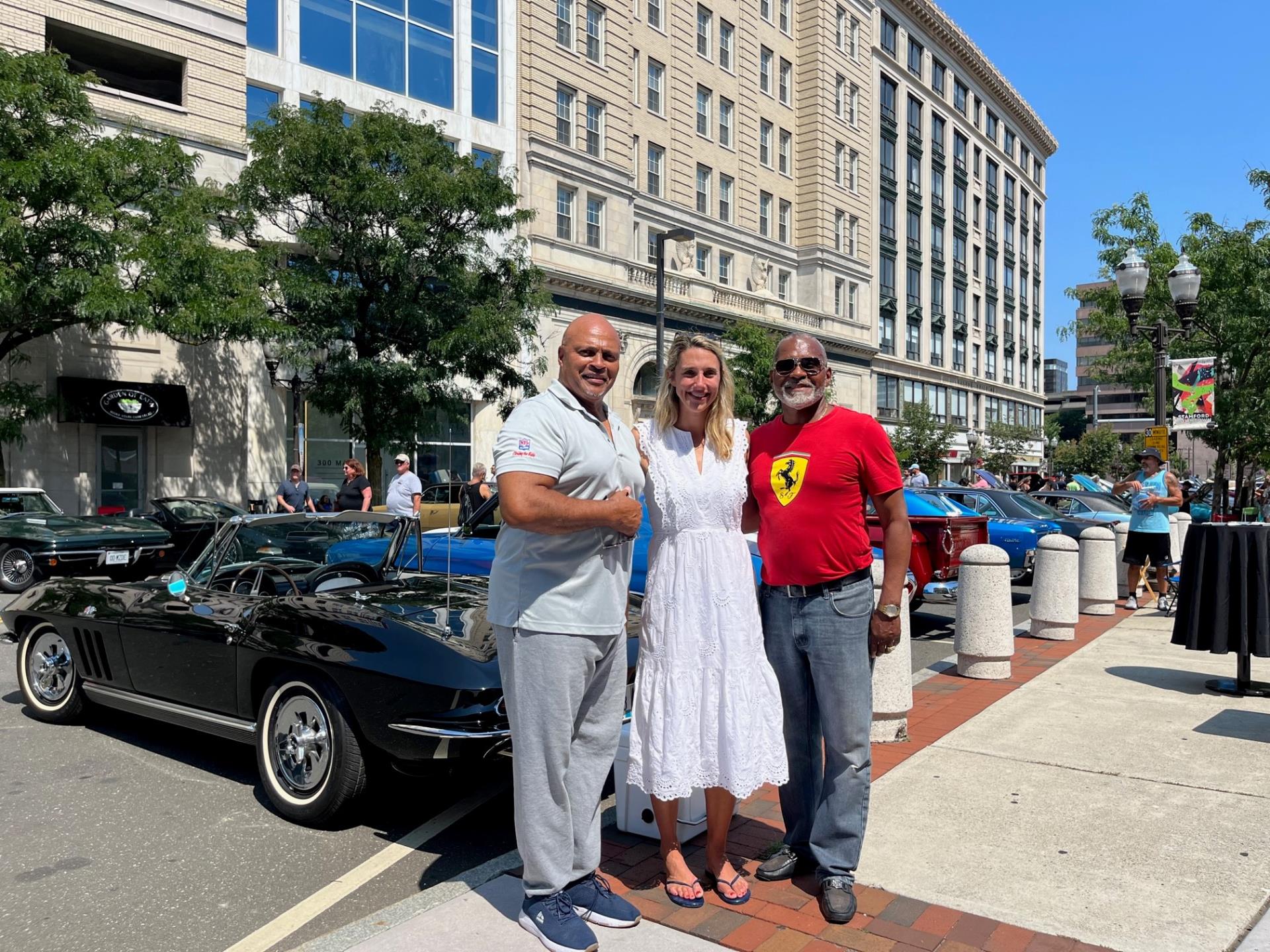 Mayor Simmons smiles for a photo with the founders of the Synergy Car Show in Stamford