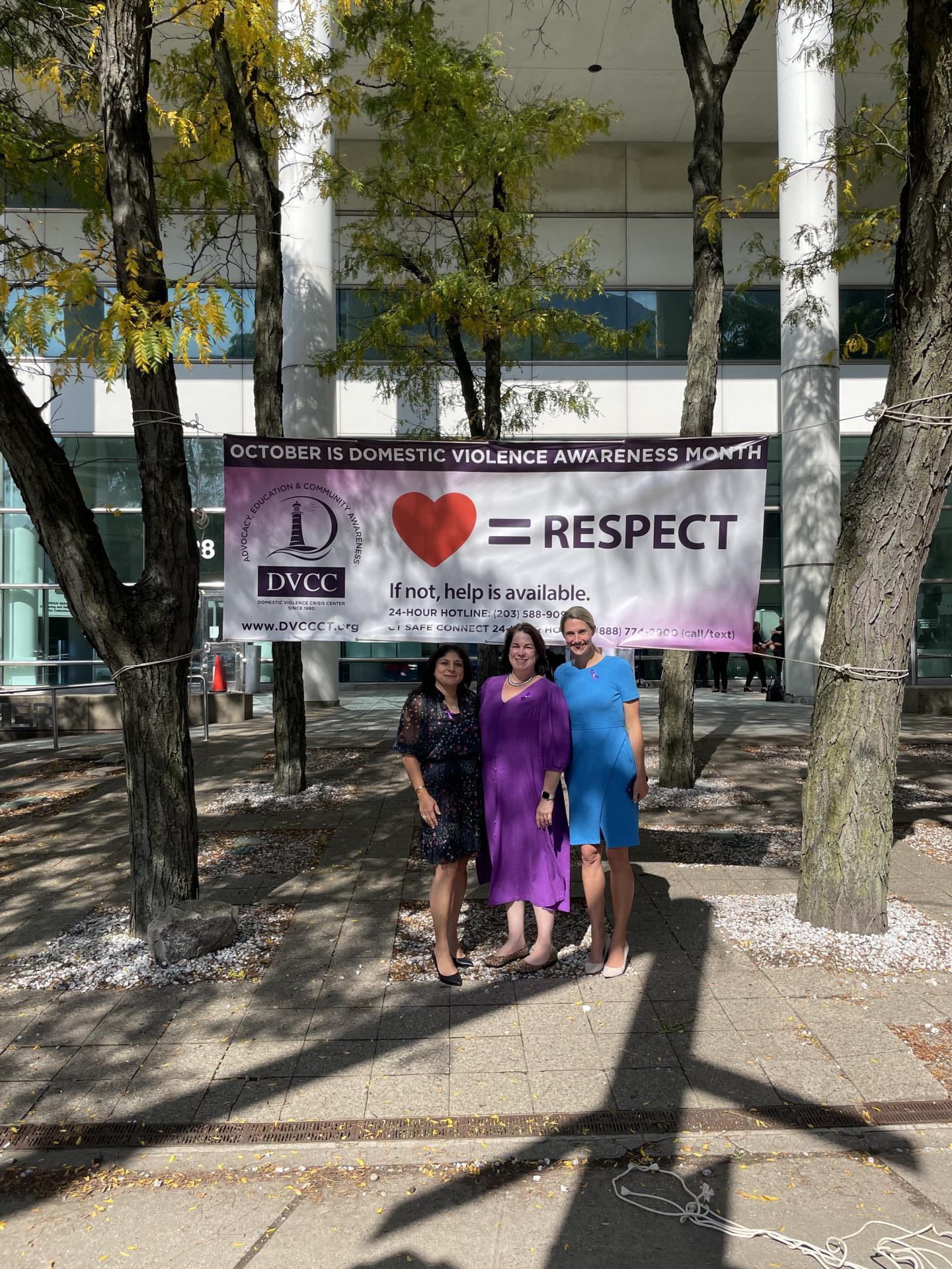 Mayor Simmons smiles for a photo in front of government center with Suzanna Adam, Executive Director of the Domestic Violence Crisis Center and a member of her team