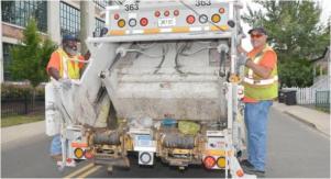 sanitation workers on truck